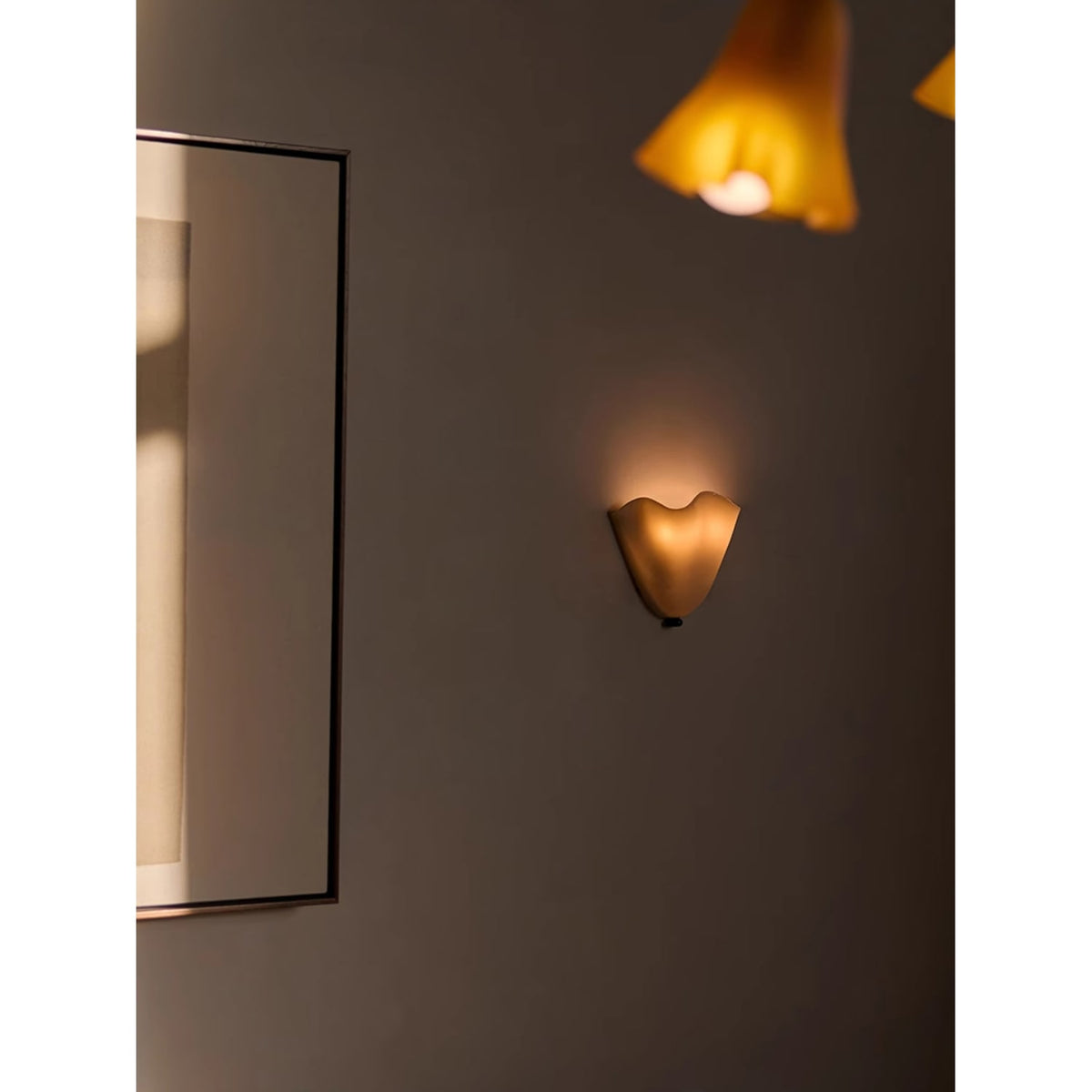 Wall Sconce with Wavy Glass Shade and Warm Ambient Lighting - Image 8
